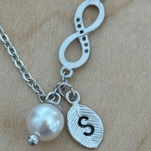 Infinity Bracelet in silver tone/ faux pearl /leaf with “S” /fits wrist size 7 …